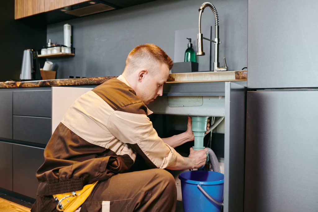 a man in uniform checking plumbing equipment after 2021 09 24 03 42 54 utc scaled