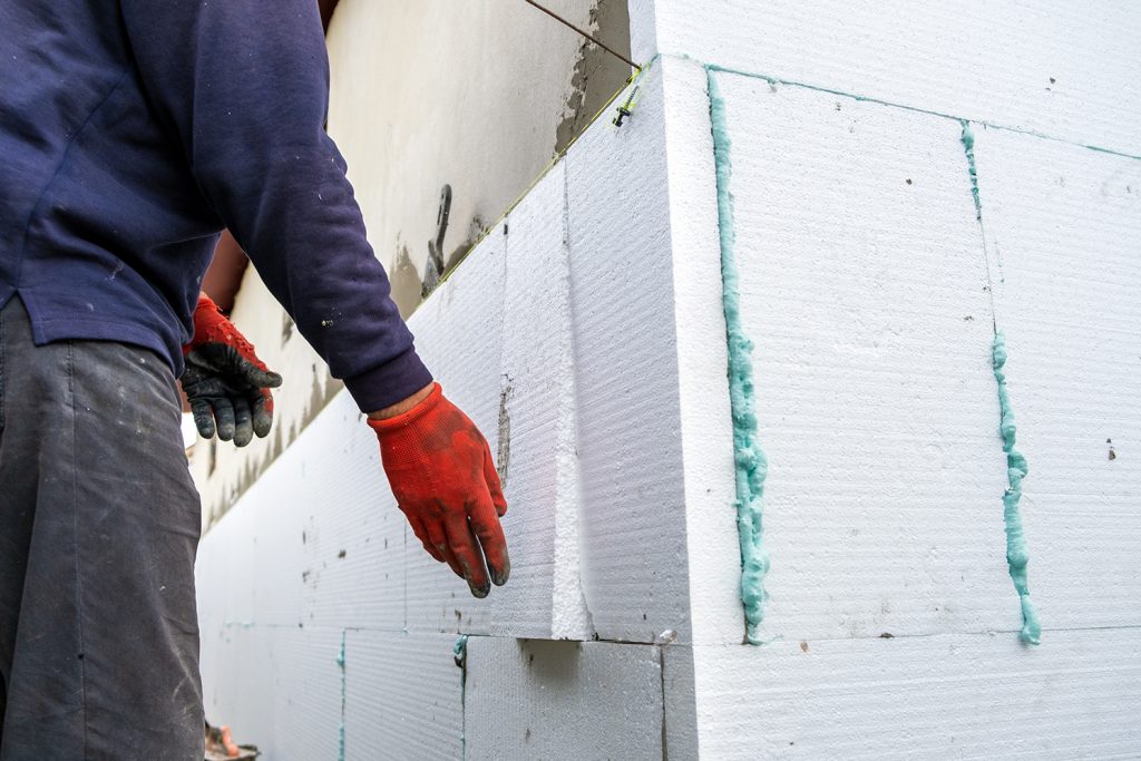 construction worker installing styrofoam insulatio 2022 05 20 18 27 16 utc